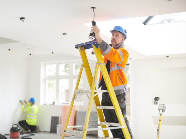 electrician installing downlights